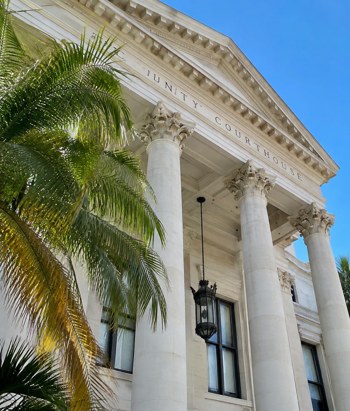 Classical Florida courthouse columns framed by palm fronds